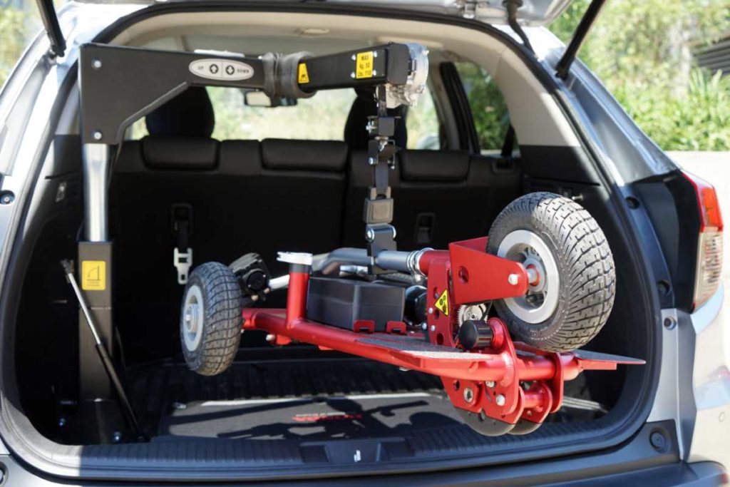 SG50 Hoist from Fadiel lifting a red scooter into the boot of a hatchback car
