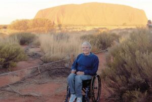 Lyn Lillecrapp with Uluru in background at sunset