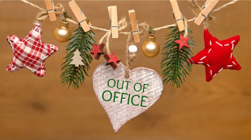 Pegs on a string holding Christmas decorations and a heart shaped 'out of office' sign