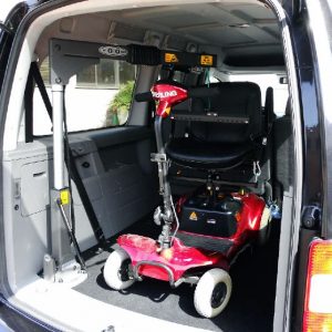 SG50 hoist with red scooter in boot of van